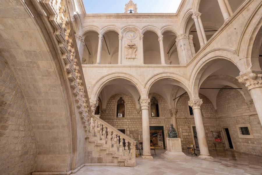 Dubrovnik, Croatia – Aug 22, 2020: Atrium stairs with bronze statue inside Rectors Palace in old town